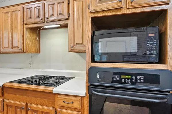 a stove top oven sitting inside of a kitchen