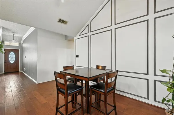 a view of a room with furniture and wooden floor