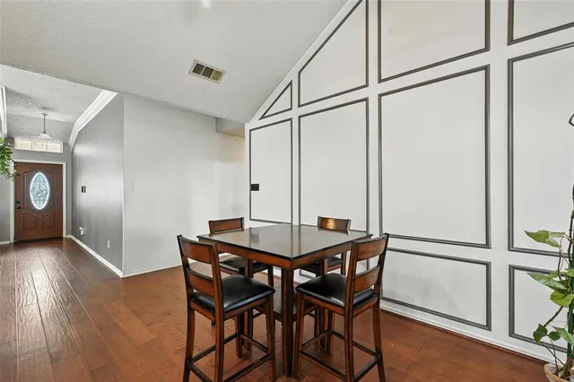 a view of a room with furniture and wooden floor