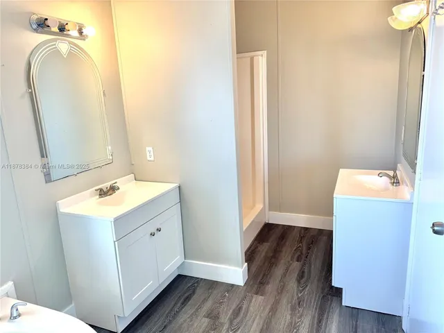 a bathroom with a sink mirror and vanity