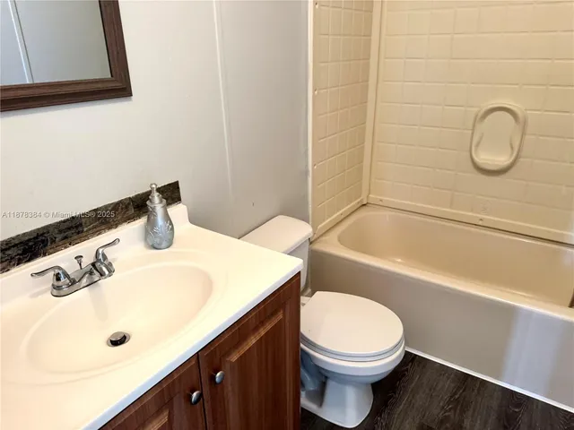 a bathroom with a sink a toilet and bathtub