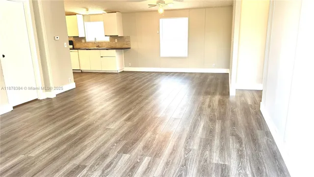 a view of a kitchen with wooden floor and a sink