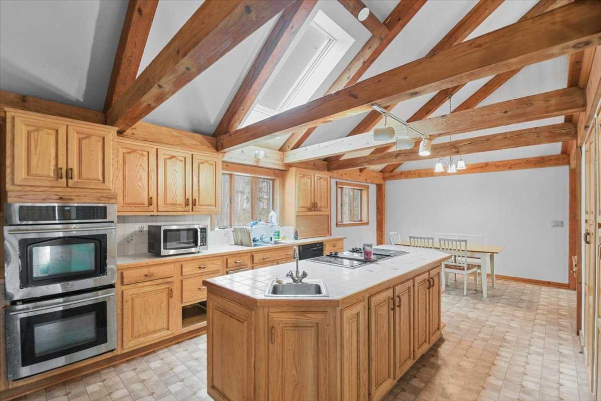 121 Cornwall Hill Road Patterson, NY 12563 - Photo 15 of 37 a kitchen with stainless steel appliances granite countertop a sink a stove and cabinets
