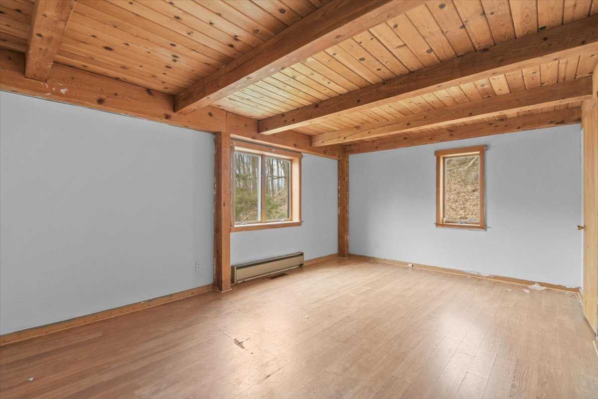 121 Cornwall Hill Road Patterson, NY 12563 - Photo 20 of 37 a view of an empty room with wooden floor and a window