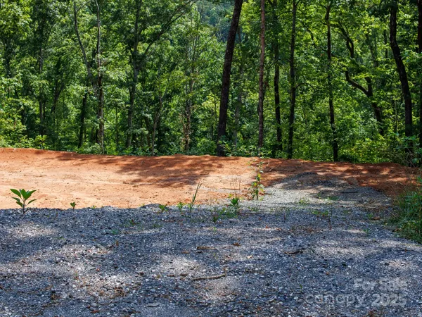 a view of dirt with green space