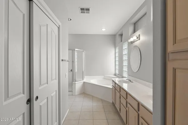 a spacious bathroom with a double vanity sink and a mirror