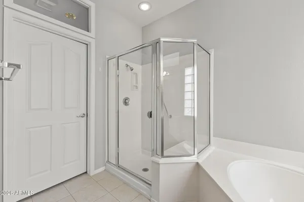 a bathroom with a glass shower door