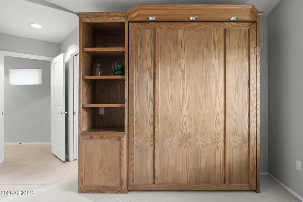 a view of a closet area with hardwood floor