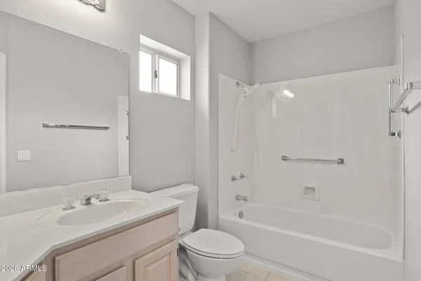 a bathroom with a granite countertop toilet a sink and a bathtub