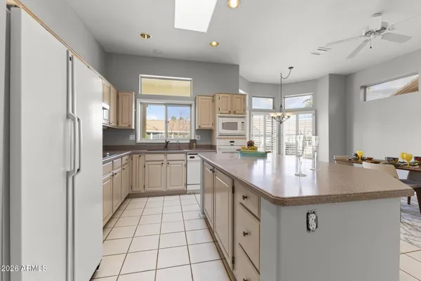 a kitchen with stainless steel appliances granite countertop a sink counter space cabinets and a large window