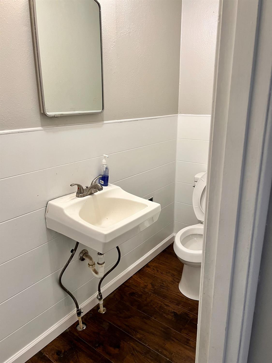 212 12th Street Ralls, TX 79357 - Photo 11 of 24 a bathroom with a sink a toilet and a mirror