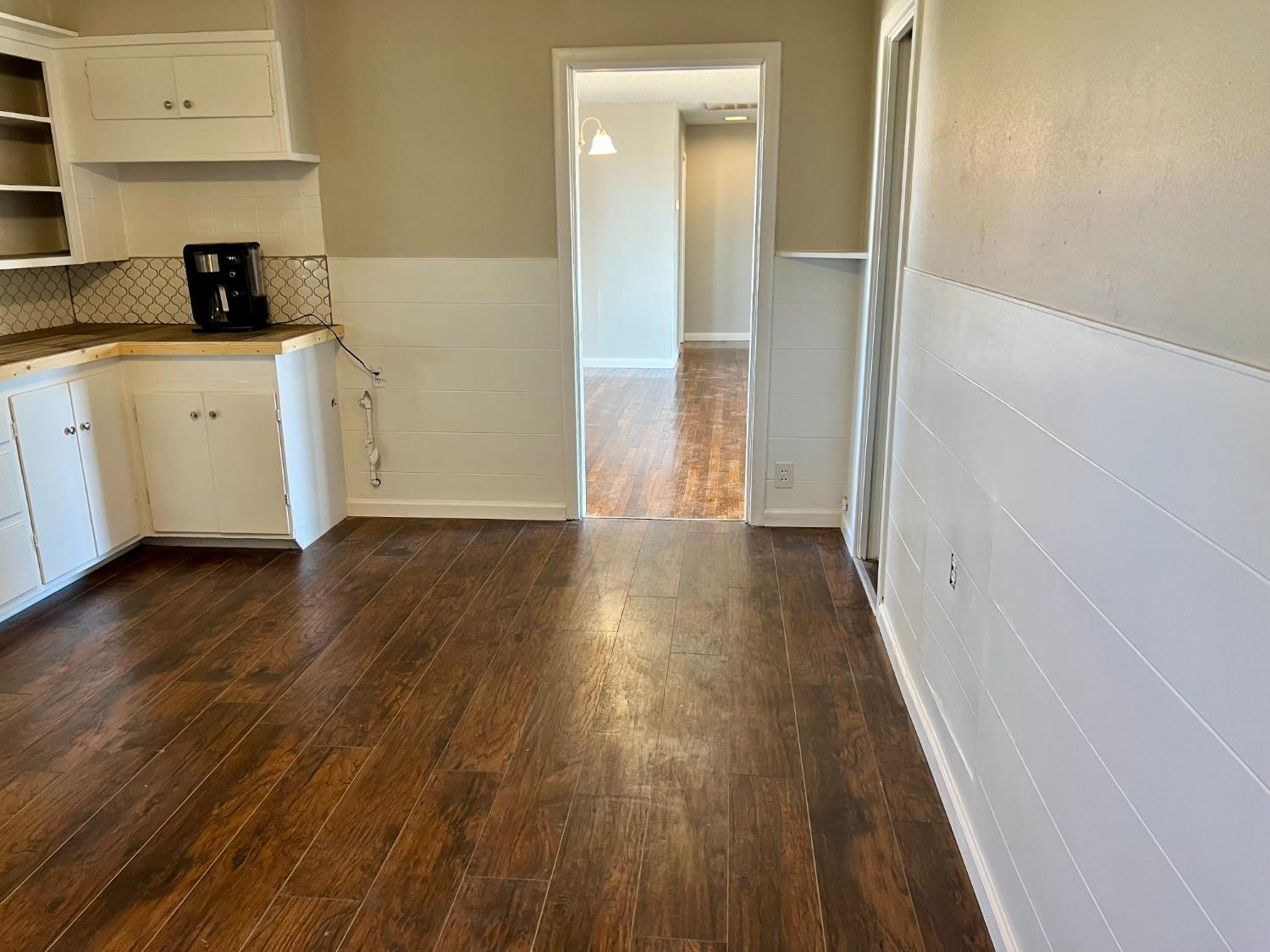 212 12th Street Ralls, TX 79357 - Photo 8 of 24 a view of a kitchen with wooden floor and a sink