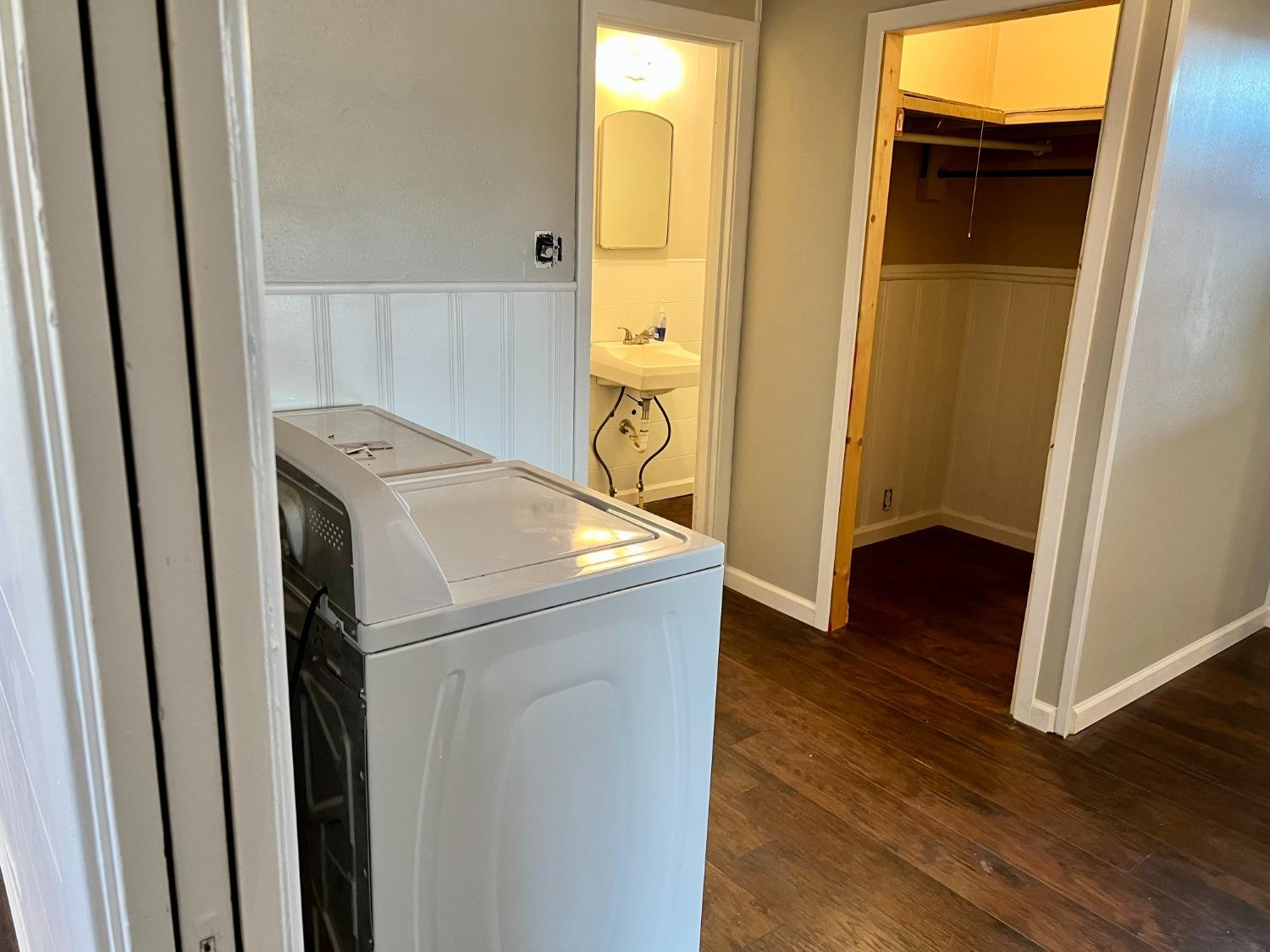 212 12th Street Ralls, TX 79357 - Photo 9 of 24 a utility room with wooden floor washer and dryer