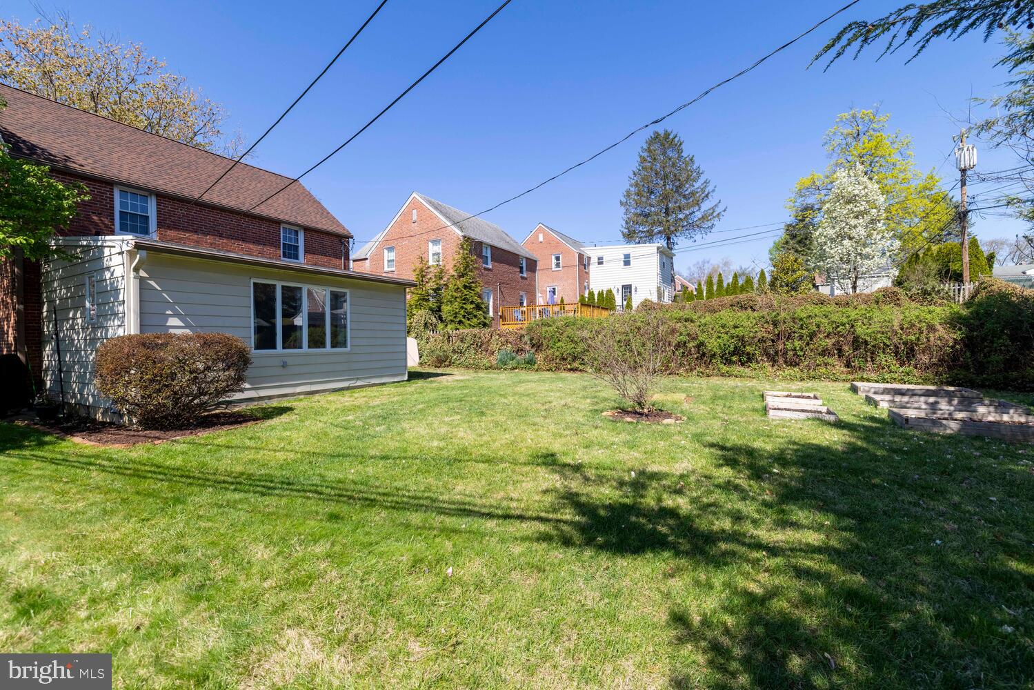 315 Edgemore Road Secane, PA 19018 - Photo 33 of 35 Sunny backyard oasis with lush greenery.