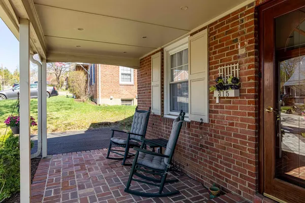 a view of a balcony with chairs and table in the patio