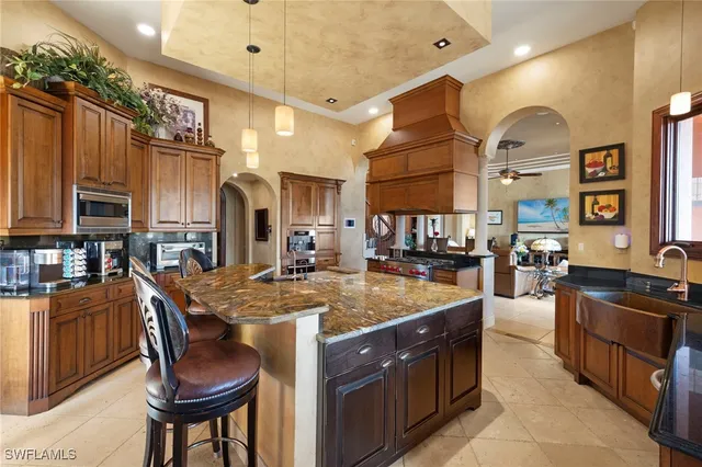 a kitchen with stainless steel appliances granite countertop a sink and cabinets