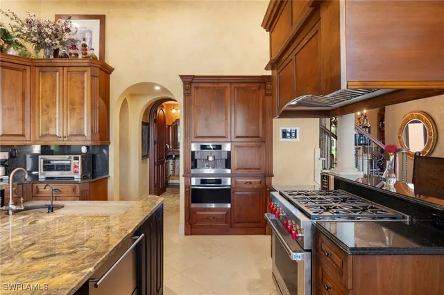 a kitchen with stainless steel appliances granite countertop a stove and a refrigerator