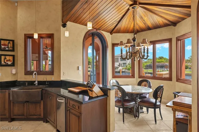 a kitchen with a table chairs and a sink