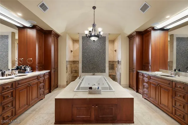 a bathroom with a granite countertop sink a large mirror and a shower