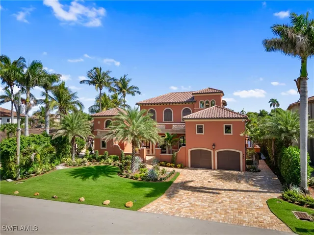 a view of a white house with a yard and plants