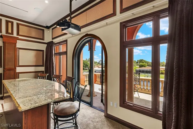 a dining room with furniture a rug and a large window