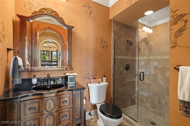 a bathroom with a sink a toilet and a shower