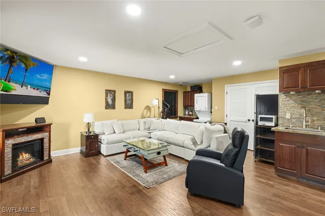 a living room with fireplace furniture and a wooden floor