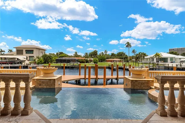 a view of a swimming pool with a table and chairs
