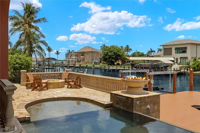 a view of a swimming pool with a patio and a yard