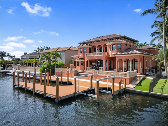 a view of a house with swimming pool and sitting area
