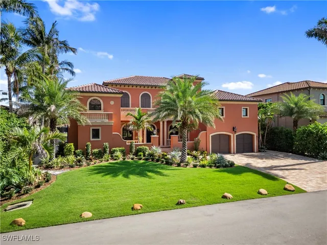 a front view of a house with a garden and plants