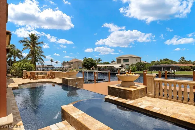 a view of a swimming pool with couches and lounge chairs