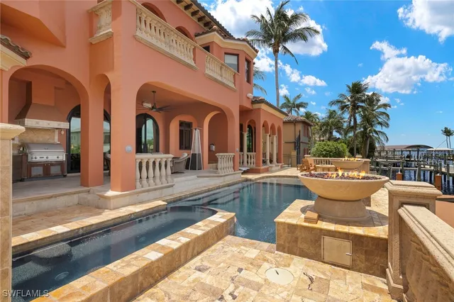a view of a house with swimming pool and sitting area