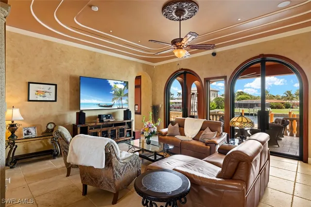 a living room with furniture a fireplace and a chandelier