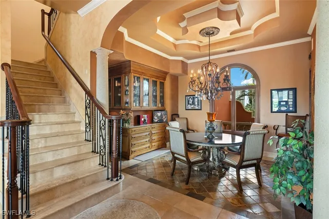 a view of a dining room with furniture and a chandelier