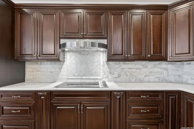 a view of empty room with a fireplace and a window