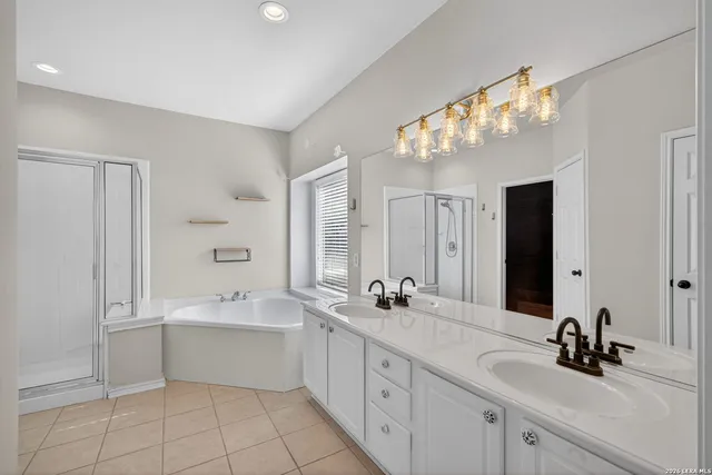 a bathroom with a double vanity sink and a mirror