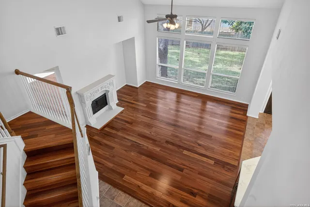 a view of room with wooden floor and white walls