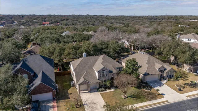 an aerial view of a house with a yard