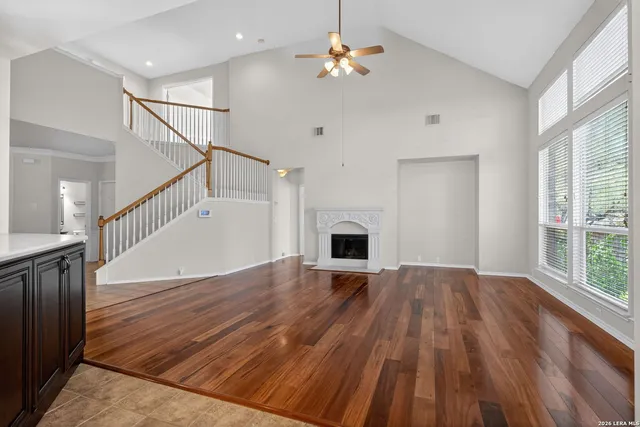 a view of a livingroom with wooden floor and a ceiling fan