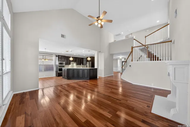a open kitchen with stainless steel appliances granite countertop a refrigerator and a sink
