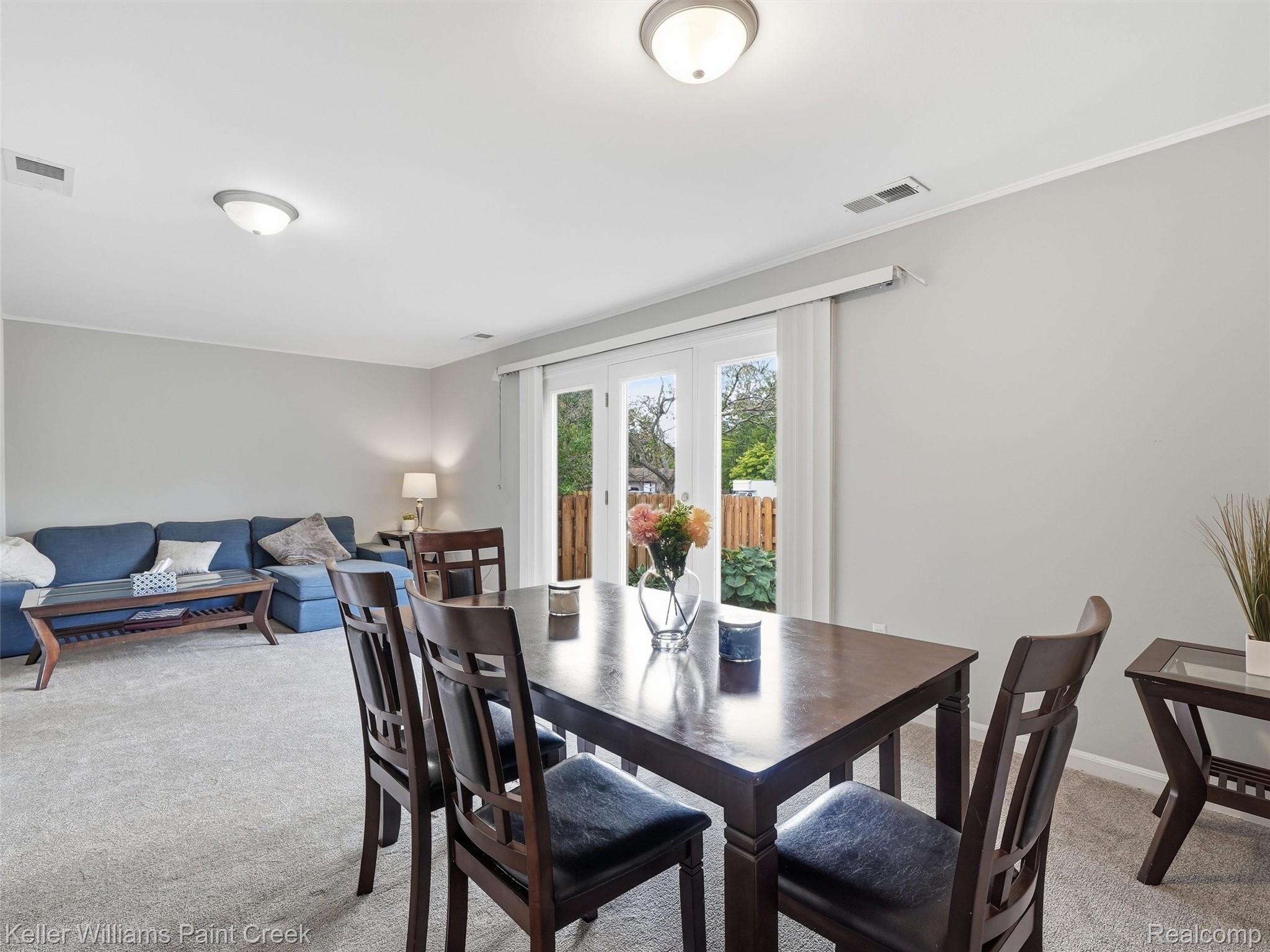 1208 Lear Court Rochester, MI 48307 - Photo 9 of 28 Recessed lighting, light gray wall paint, white trim, and direct access to outdoor space
