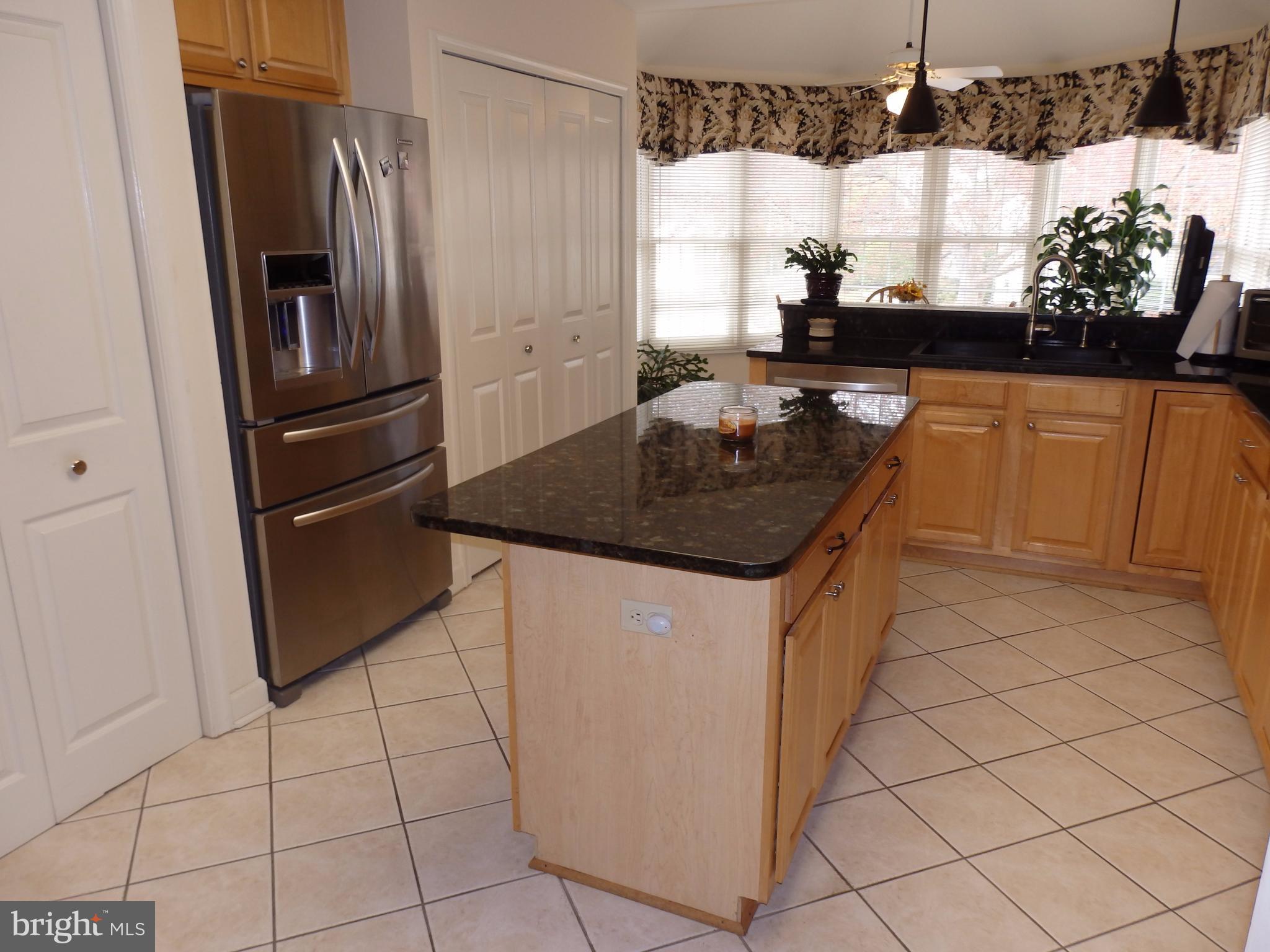 2415 Bear Den Road Frederick, MD 21701 - Photo 8 of 29 a kitchen with stainless steel appliances granite countertop a sink a refrigerator and a counter