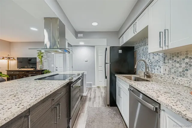 a kitchen with a stove and refrigerator