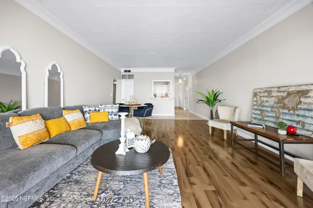 a patio with table and chairs and potted plants