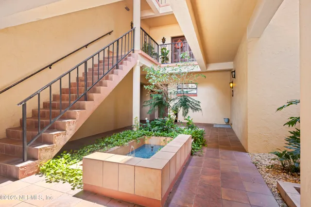a bathroom with a granite countertop toilet a sink and a mirror