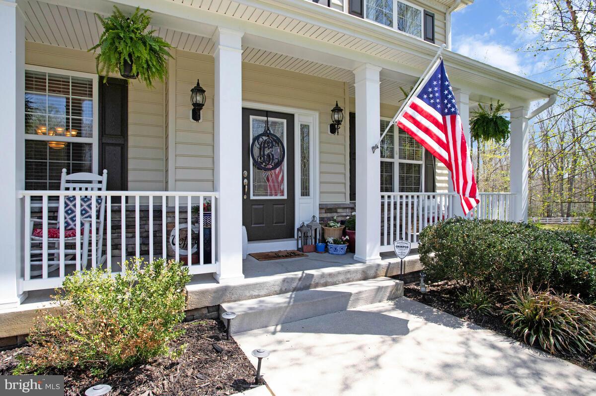 54 Simmons Ridge Road Prince Frederick, MD 20678 - Photo 4 of 55 a view of a house with a small yard and plants