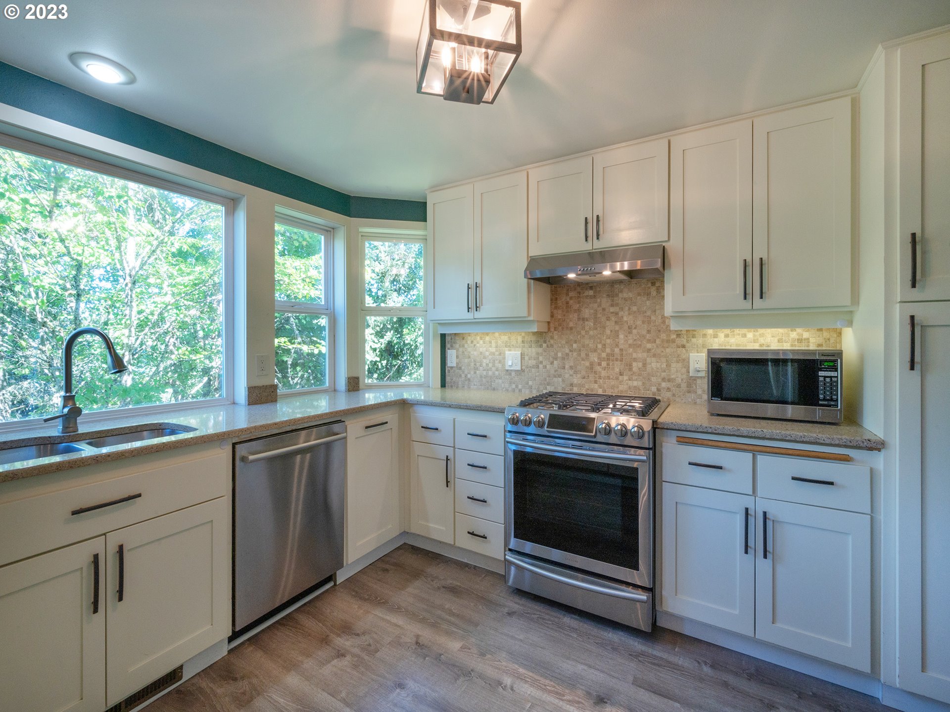 3875 Ashford Drive Eugene, OR 97405 - Photo 12 of 44 a kitchen with granite countertop white cabinets and appliances