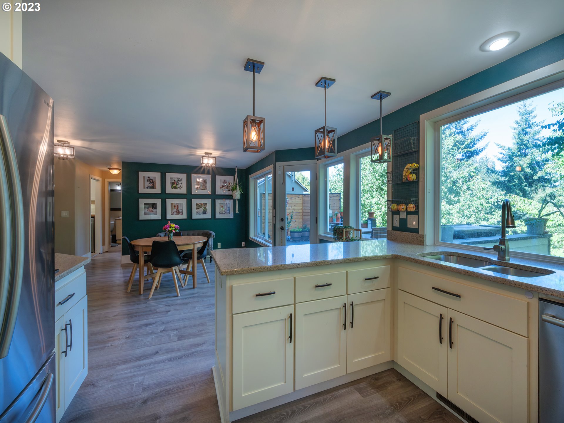 3875 Ashford Drive Eugene, OR 97405 - Photo 13 of 44 a kitchen with white cabinets and wooden floors