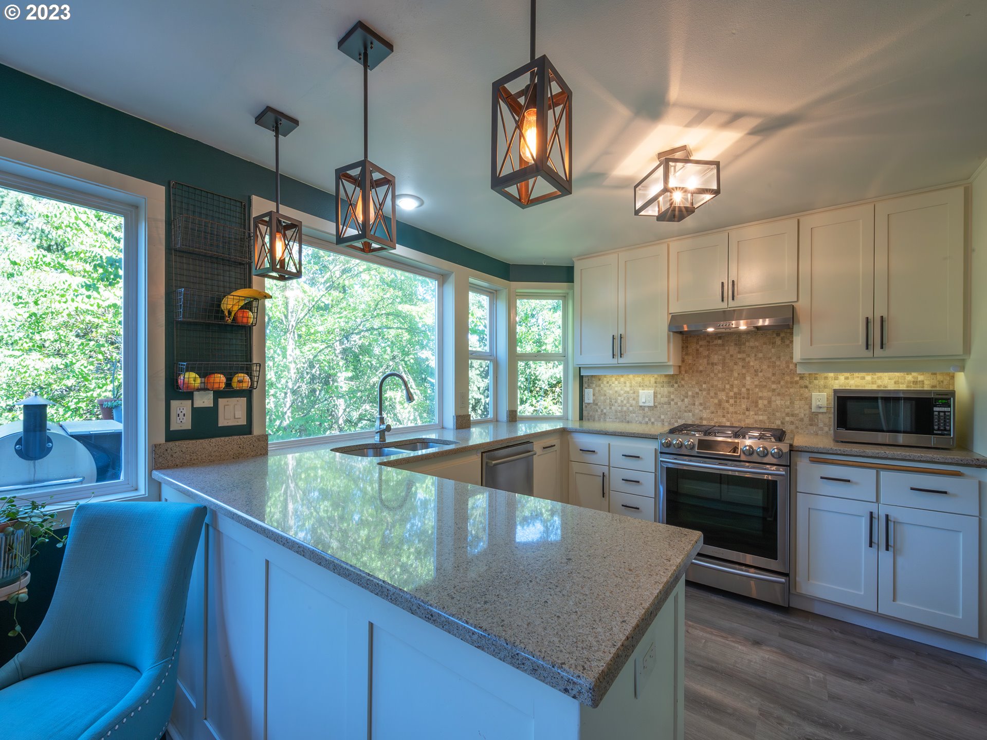 3875 Ashford Drive Eugene, OR 97405 - Photo 15 of 44 a kitchen with granite countertop stainless steel appliances a stove and a large window